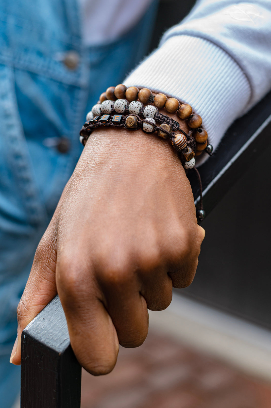 Handcrafted wooden bead bracelet with natural mineral stones on wrist