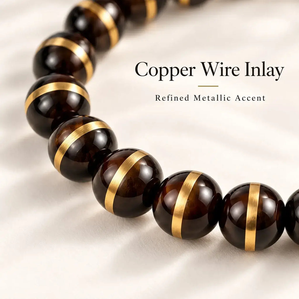 Close-up of copper wire line detailing around polished black and dark-brown Zijinshu beads