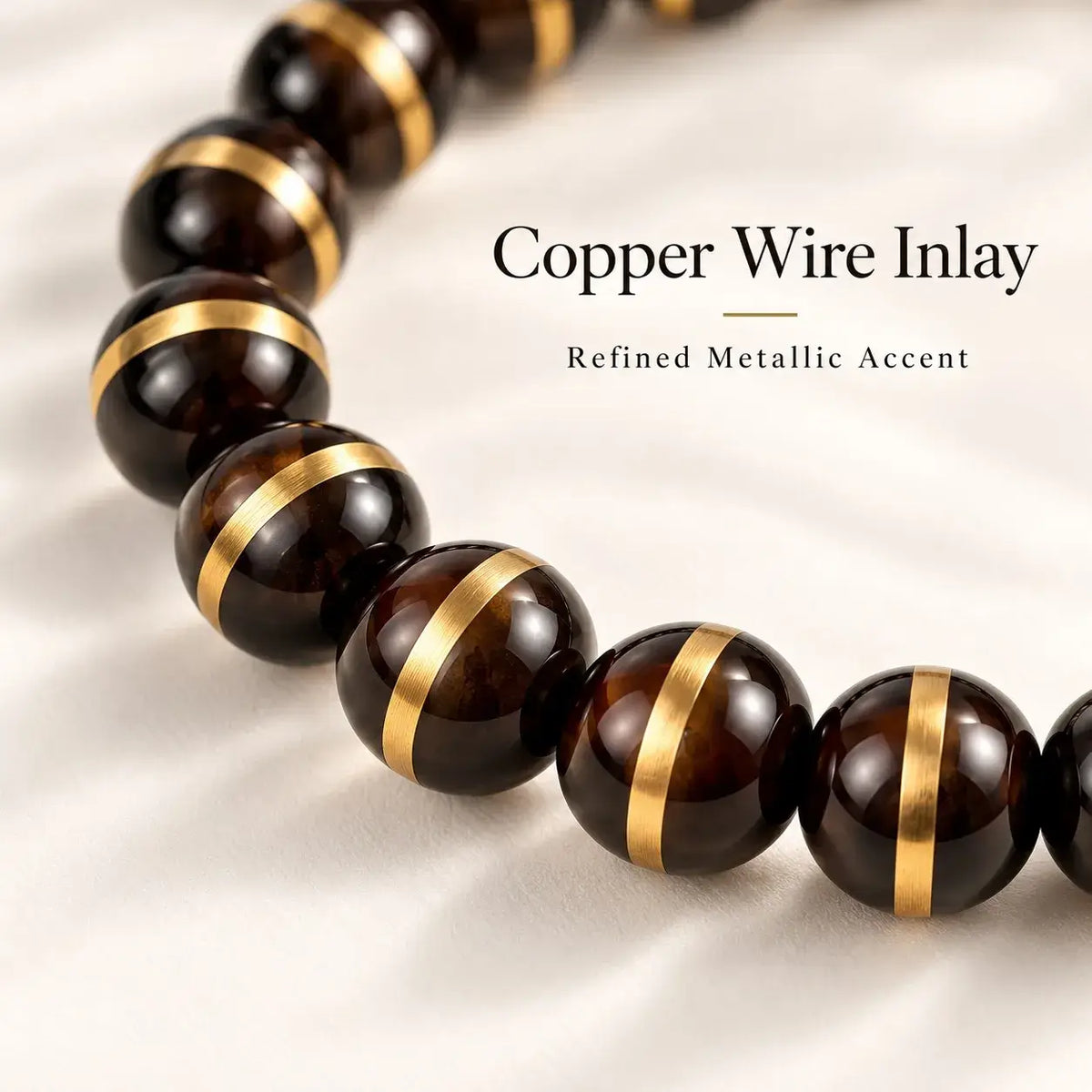 Close-up of copper wire line detailing around polished black and dark-brown Zijinshu beads