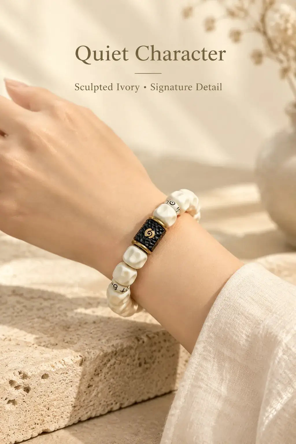 Ivory-colored sculpted bead bracelet worn on the wrist