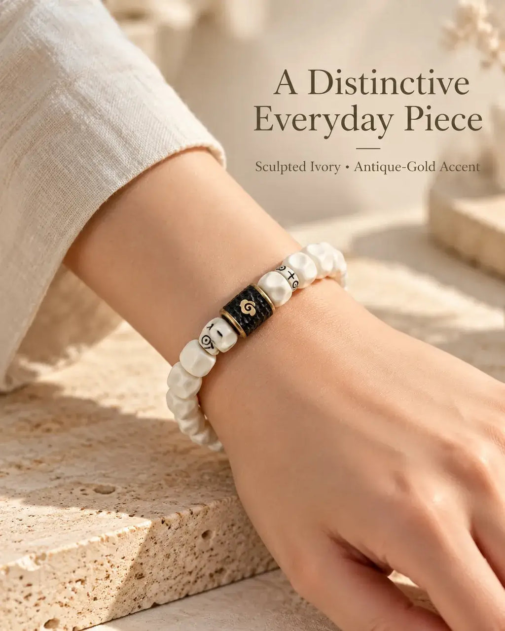 Pale carved bead bracelet styled with a light sleeve