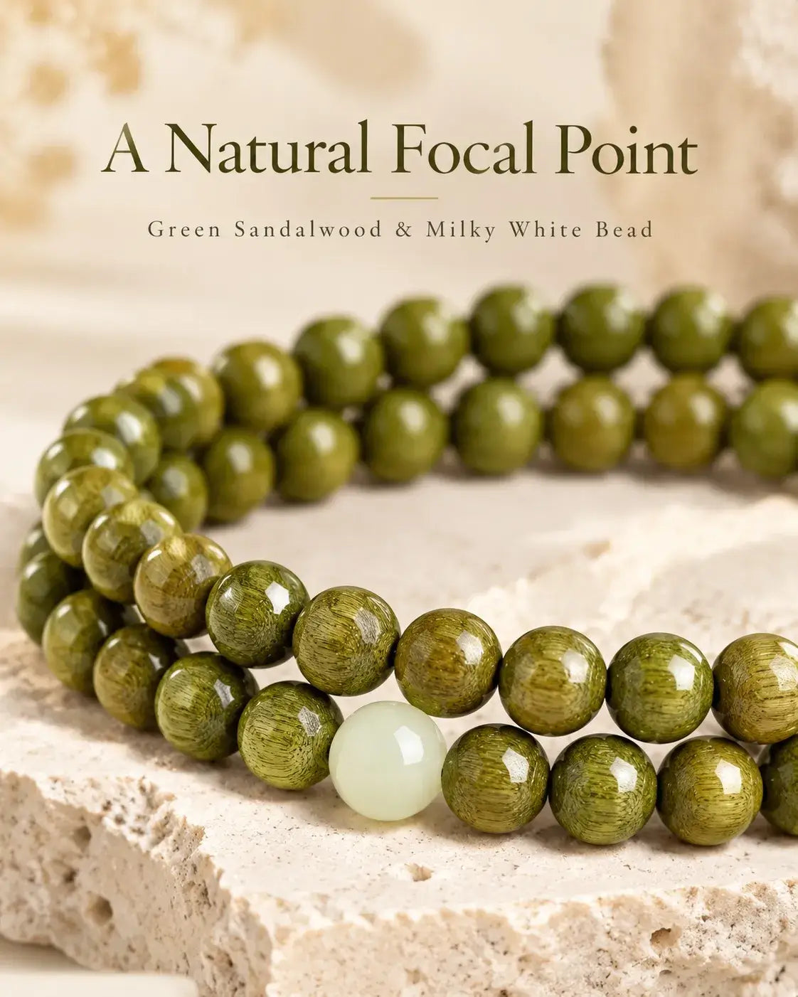 Detail of fine green sandalwood grain and the milky-white focal bead
