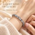 Natural gray moonstone bracelet with blue flashes worn on the wrist