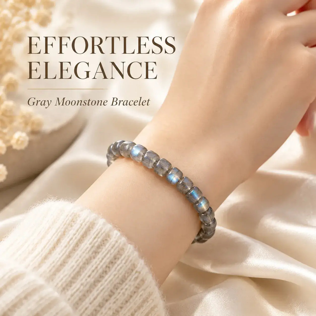 Gray moonstone bead bracelet styled with a cream sleeve