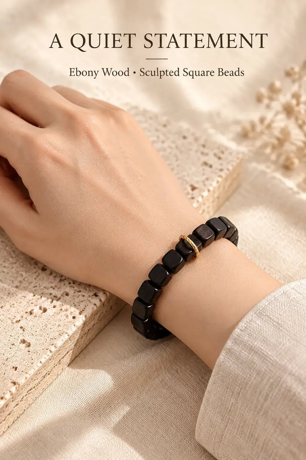Black and dark brown ebony cube bead bracelet worn on the wrist