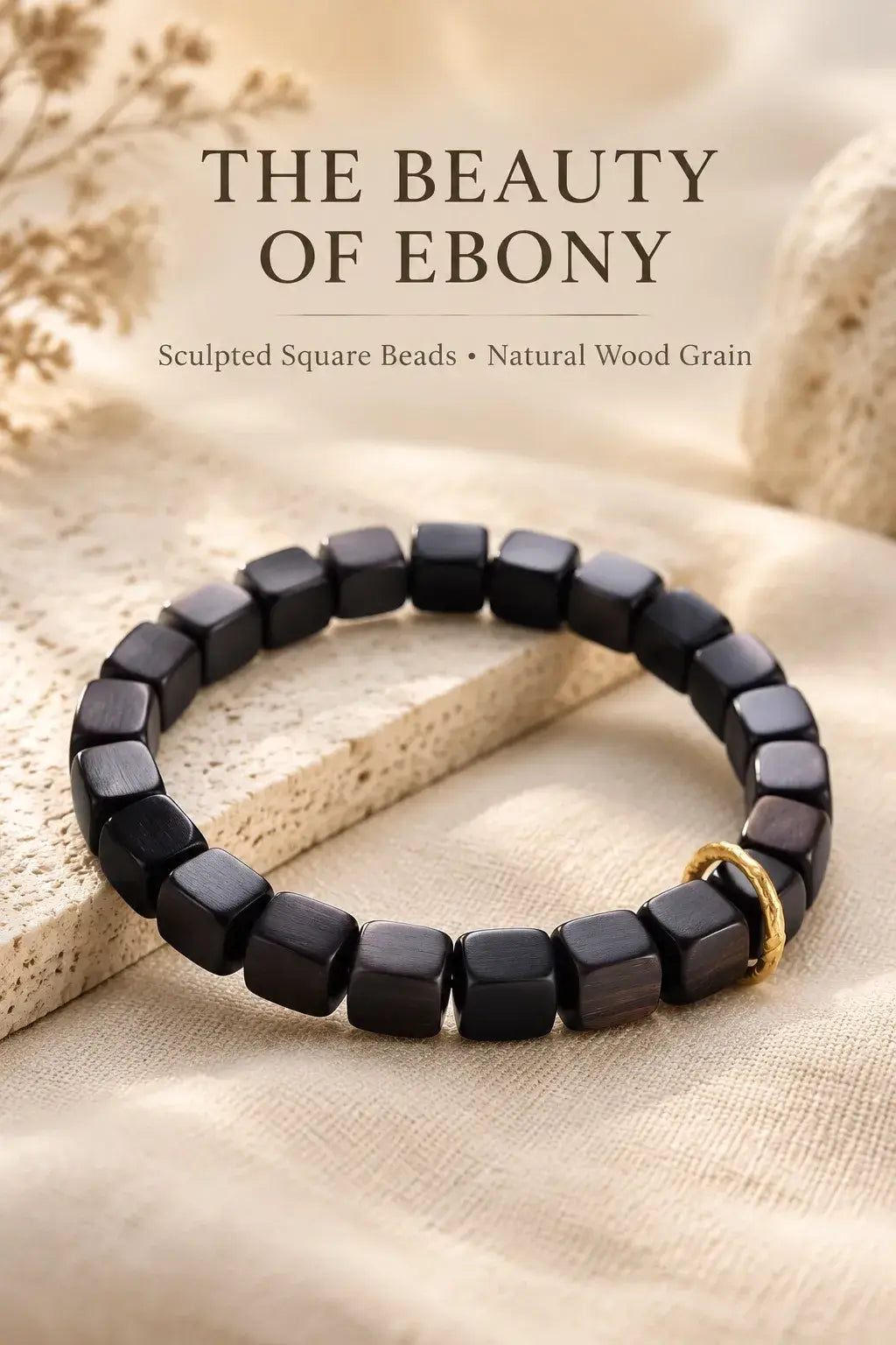 Full view of a natural ebony square bead bracelet on pale stone