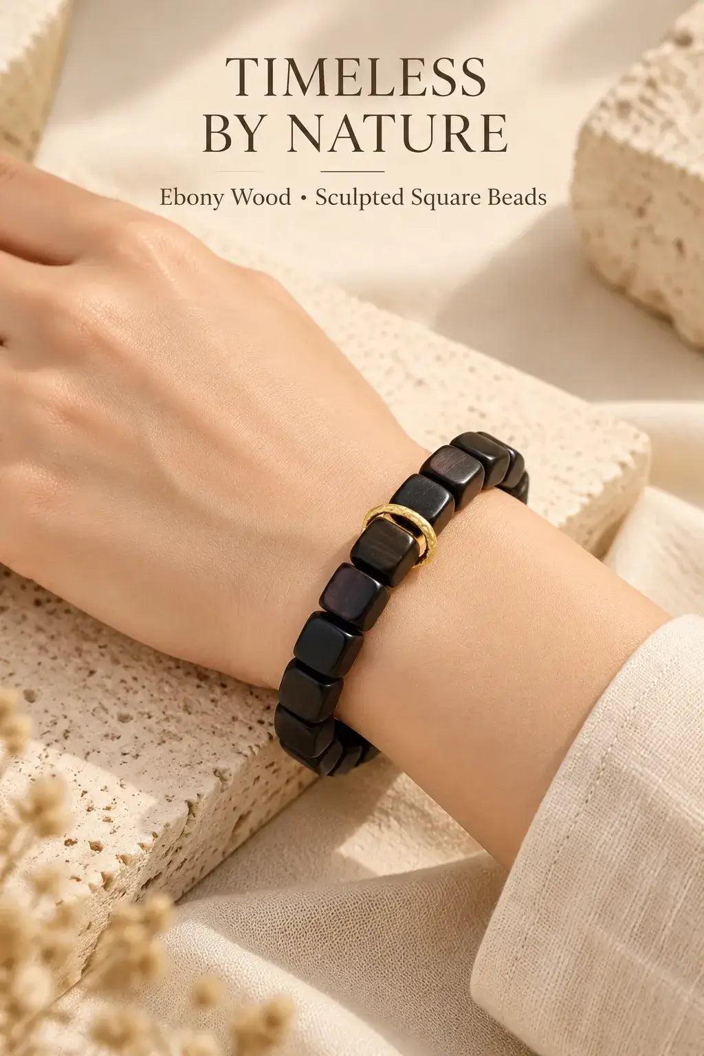 Ebony sugar cube bracelet styled with a cream sleeve and gold-tone ring detail