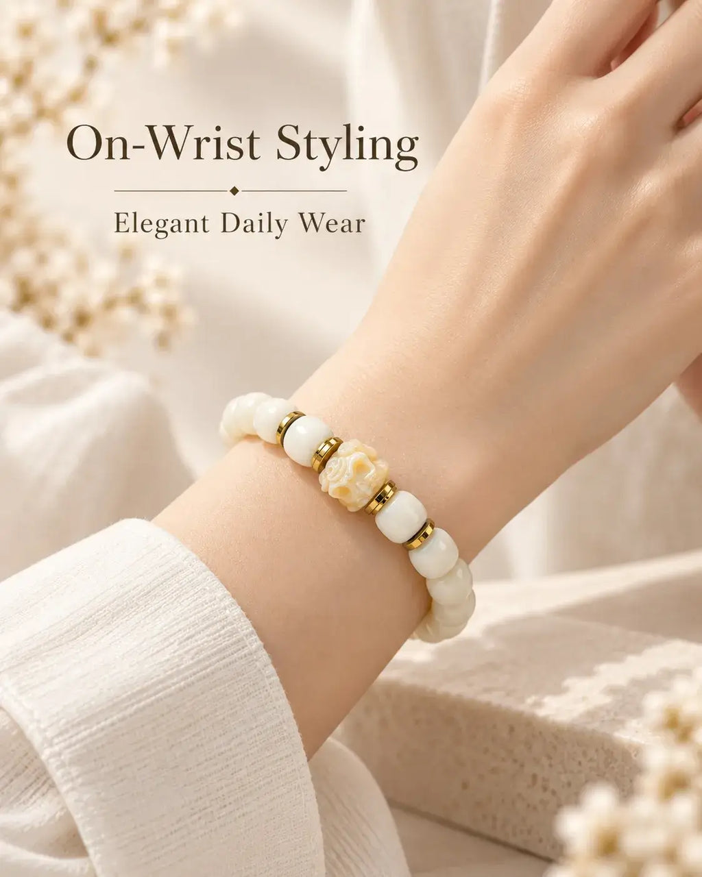 White jade bodhi seed bracelet worn on the wrist beside an ivory sleeve