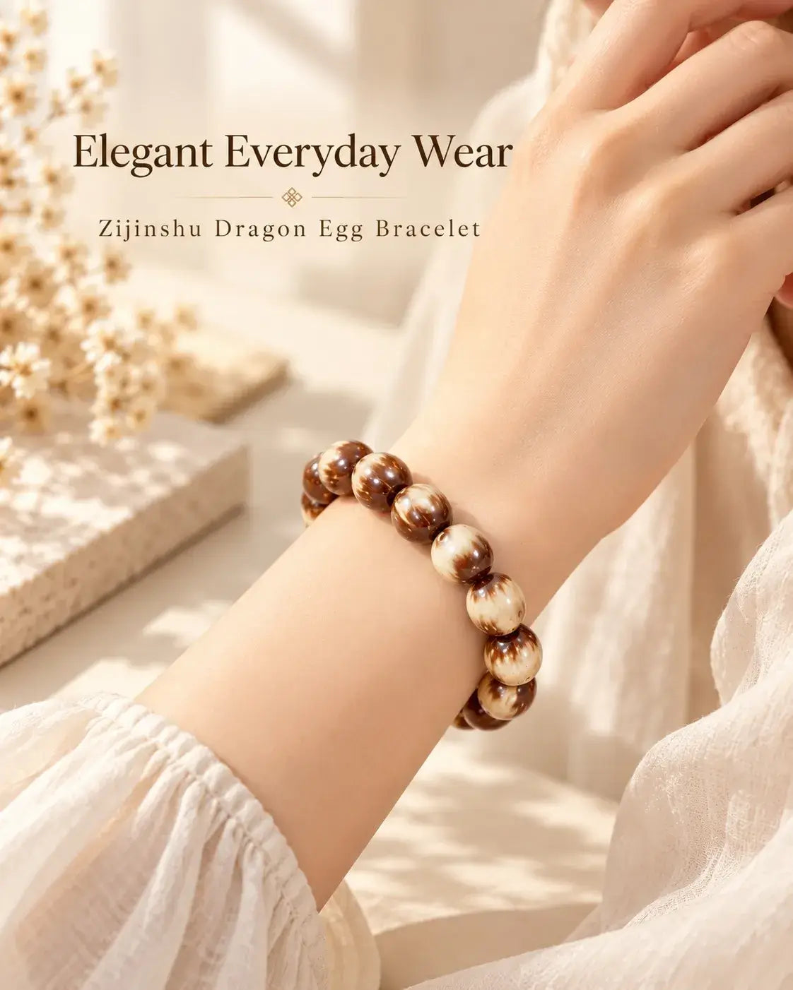 Three-eye Zijinshu Dragon Egg bracelet worn on the wrist with a light cream sleeve