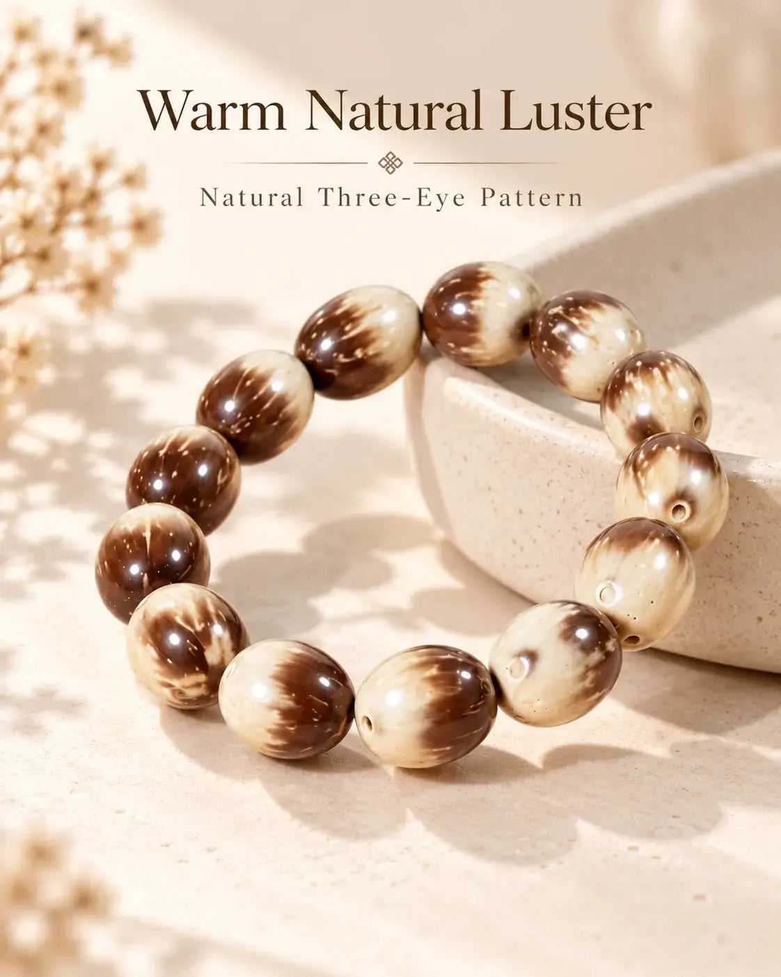 Polished brown-and-cream Zijinshu seed bracelet displayed on pale stone